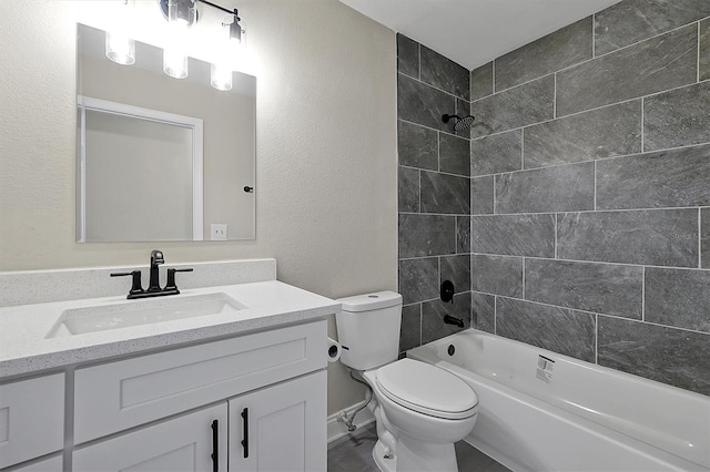 full bathroom featuring vanity, tiled shower / bath combo, and toilet