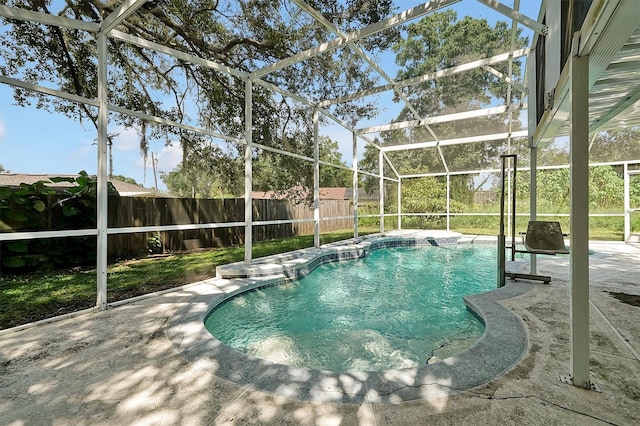 view of swimming pool with a patio and a lanai