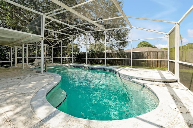 view of swimming pool with a lanai, a fenced backyard, a fenced in pool, and a patio