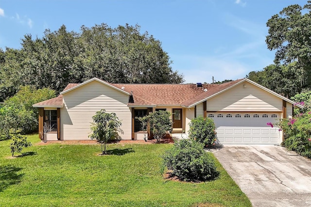 single story home with a garage, concrete driveway, and a front lawn