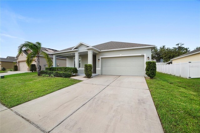 view of front of house with a garage and a front yard