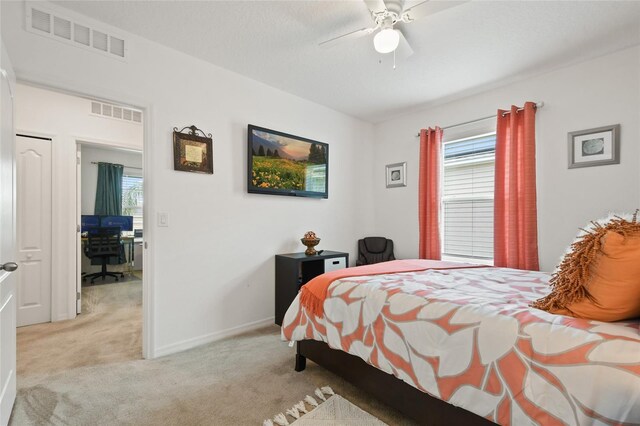 bedroom with ceiling fan and light carpet