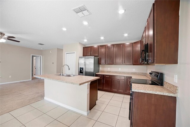 kitchen featuring stainless steel refrigerator with ice dispenser, sink, a kitchen island with sink, ceiling fan, and light carpet