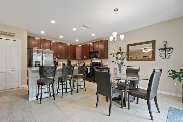 dining space with sink, a notable chandelier, and light tile patterned flooring