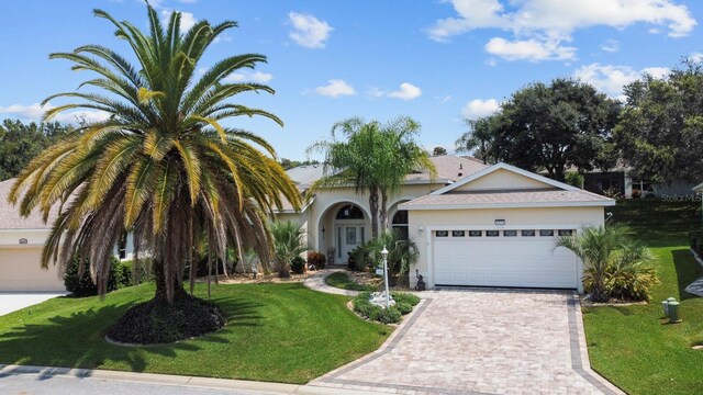 view of front of home featuring a garage and a front yard