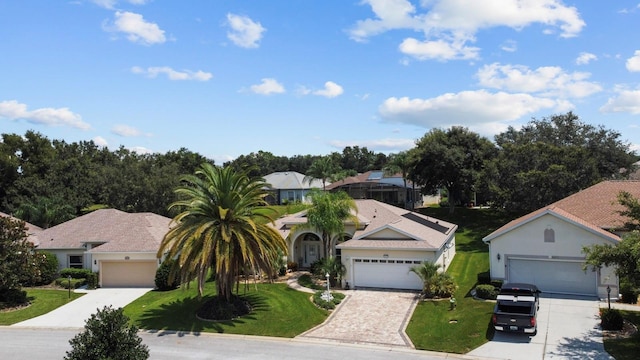 view of front of home with driveway, a garage, and a front yard