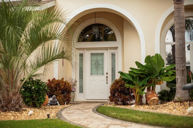 property entrance with stucco siding