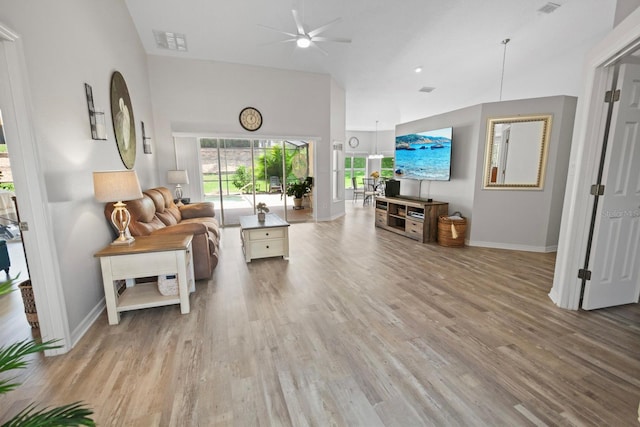 living room with light hardwood / wood-style floors and ceiling fan