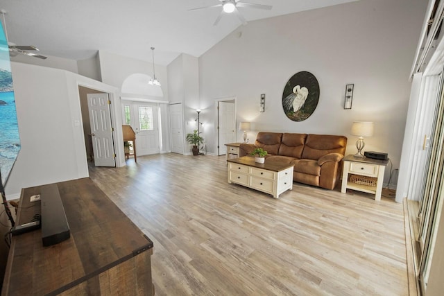 living room with light wood-style flooring, high vaulted ceiling, and ceiling fan