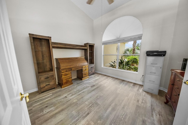 office featuring lofted ceiling, ceiling fan, light wood-style flooring, and baseboards