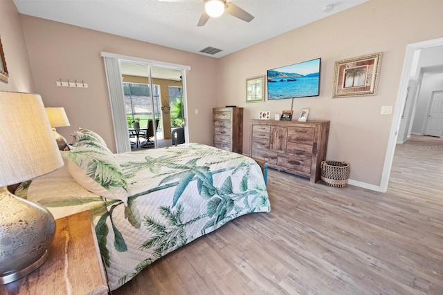 bedroom with ceiling fan, access to exterior, and wood-type flooring