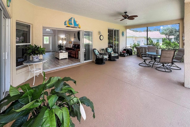 sunroom with a ceiling fan and a healthy amount of sunlight