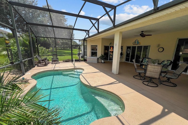 outdoor pool with ceiling fan, a patio, and a lanai