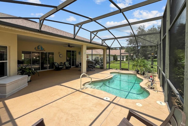 view of swimming pool featuring ceiling fan, a lanai, and a patio area