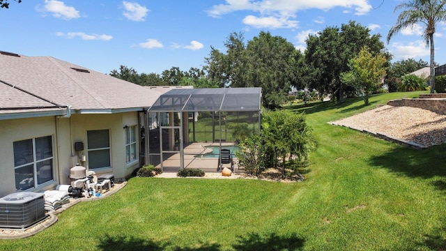 view of yard featuring glass enclosure, a patio area, an outdoor pool, and cooling unit