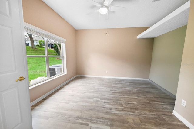 empty room with ceiling fan and hardwood / wood-style floors