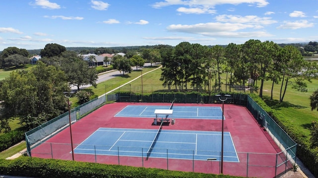 view of sport court featuring fence