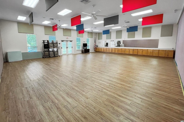 workout room featuring ceiling fan and light wood-type flooring