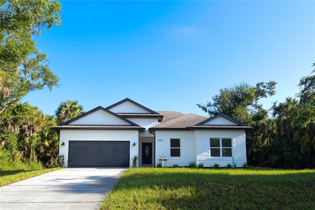 ranch-style house featuring a front lawn and a garage