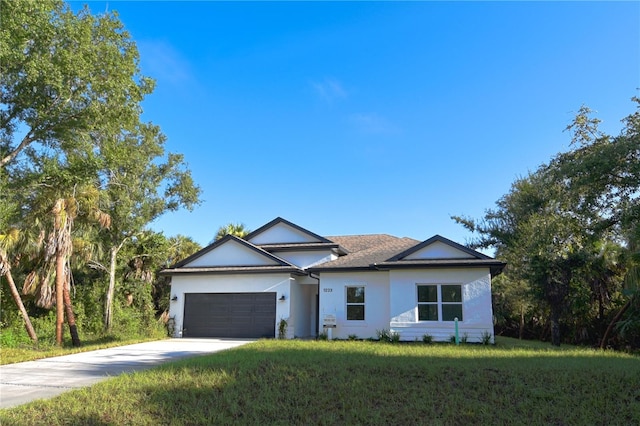 single story home with a garage and a front lawn