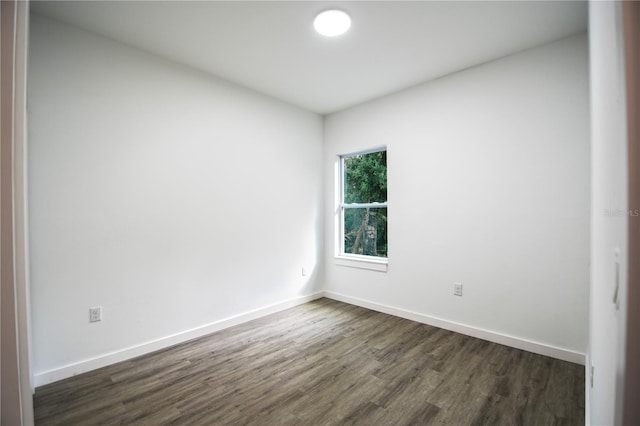 spare room with dark hardwood / wood-style floors