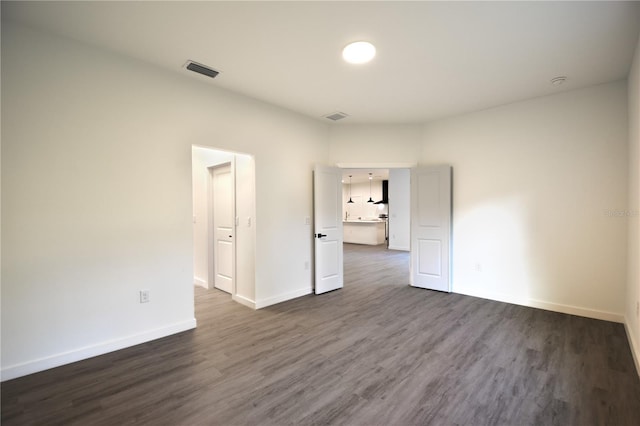 spare room featuring dark hardwood / wood-style floors