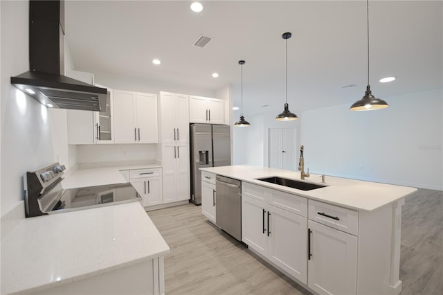 kitchen with ventilation hood, sink, appliances with stainless steel finishes, a center island with sink, and white cabinets