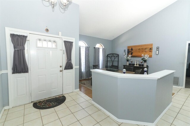 tiled foyer with vaulted ceiling