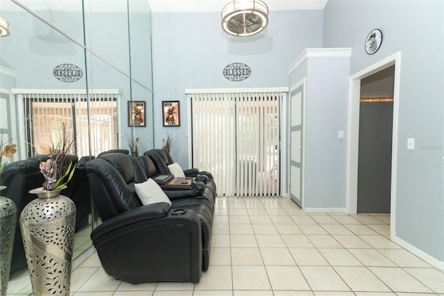 living room featuring a wealth of natural light, light tile patterned flooring, and a towering ceiling