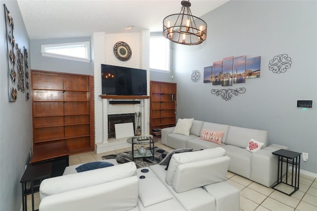 living room with high vaulted ceiling, a notable chandelier, a fireplace, a textured ceiling, and brick wall