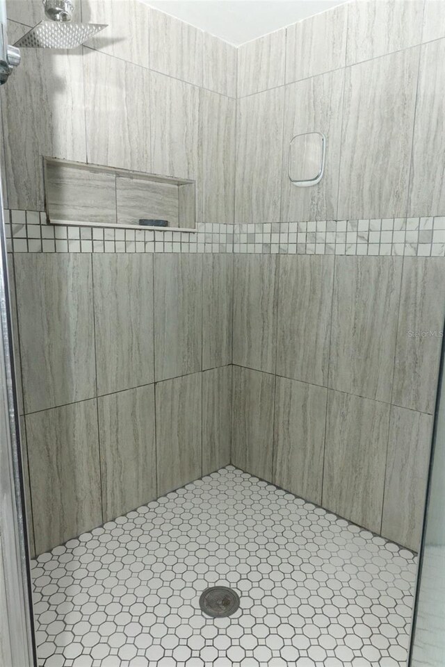 bathroom featuring a shower and tile patterned flooring