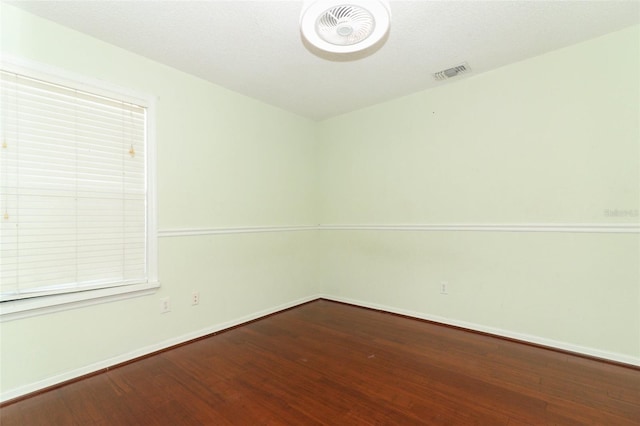 spare room with wood-type flooring