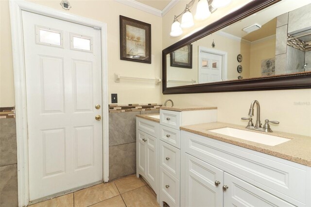 bathroom with tile patterned floors, vanity, and ornamental molding