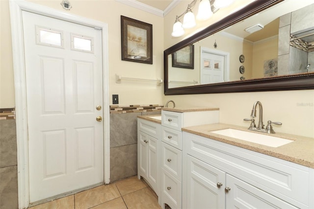 bathroom featuring tile patterned floors, a sink, tile walls, and crown molding