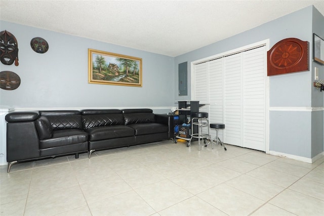 living room featuring light tile patterned floors and a textured ceiling