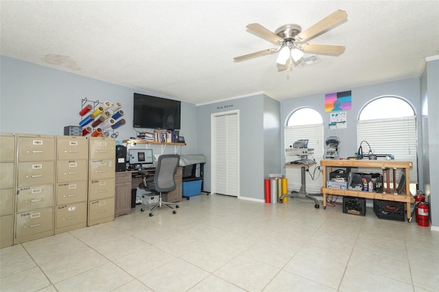 tiled office space featuring ceiling fan and a textured ceiling