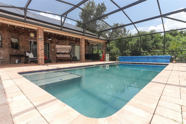 view of pool featuring a patio area, a lanai, a covered pool, and ceiling fan