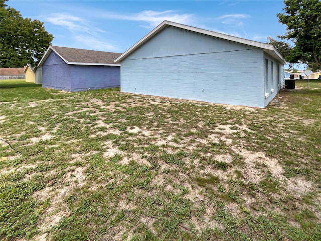 view of side of property with a lawn