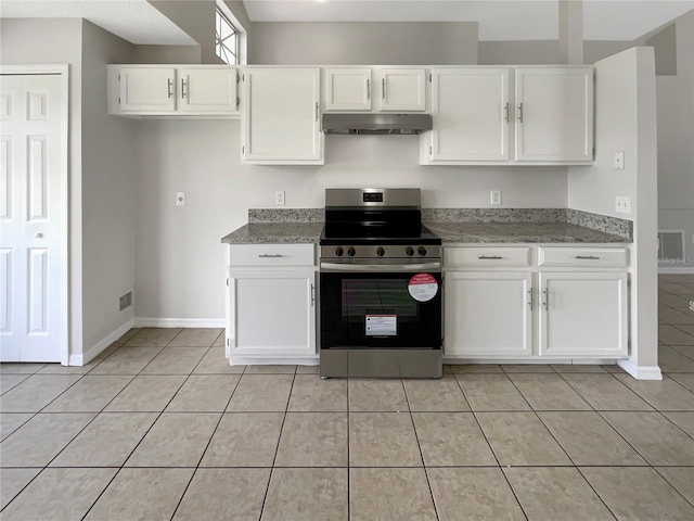 kitchen featuring stainless steel electric range, white cabinets, stone countertops, and light tile patterned floors