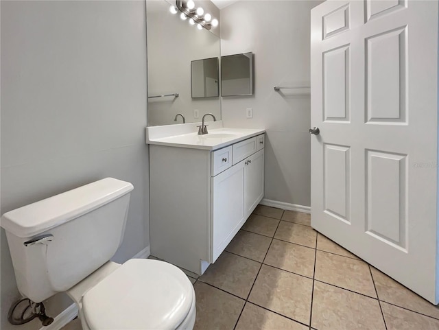 bathroom featuring toilet, vanity, and tile patterned flooring