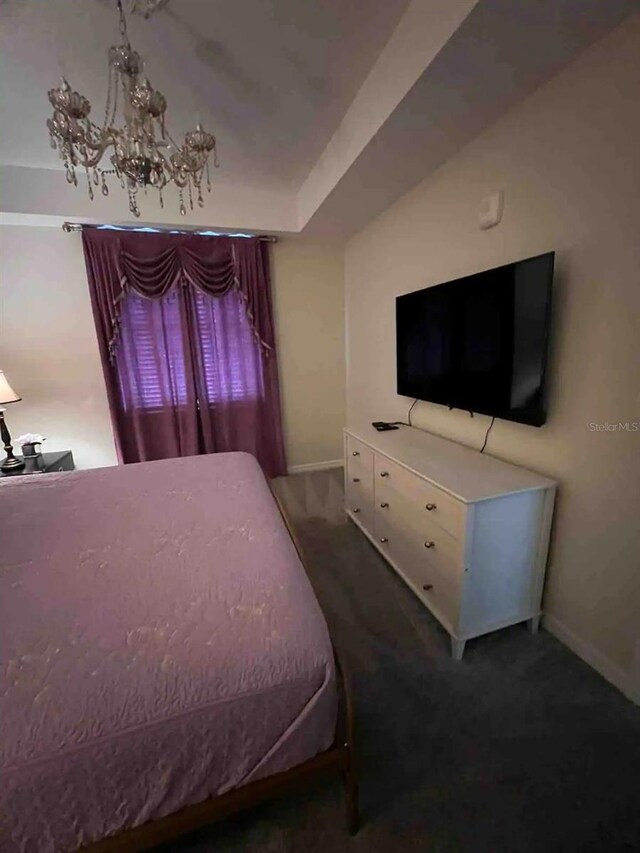 carpeted bedroom with a chandelier