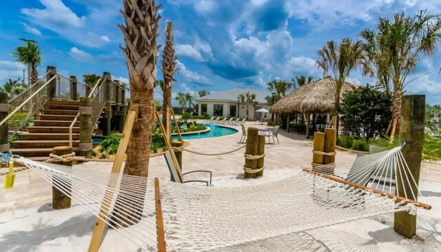 exterior space with a pool and a patio