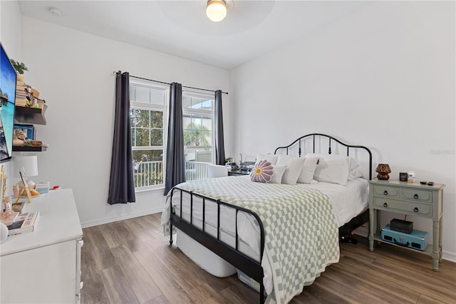 bedroom with baseboards and dark wood finished floors