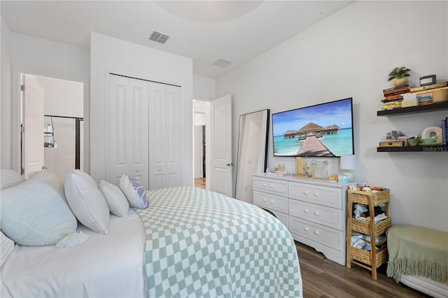 bedroom featuring dark wood-type flooring, a closet, and visible vents