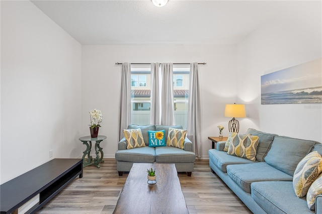 living room with light wood-style floors and baseboards