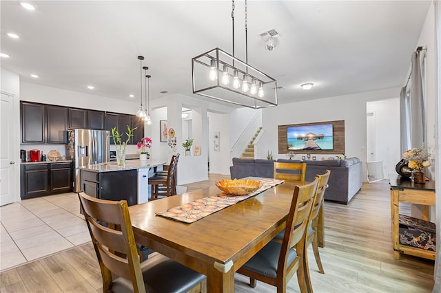 dining area featuring stairway, light wood-style flooring, visible vents, and recessed lighting