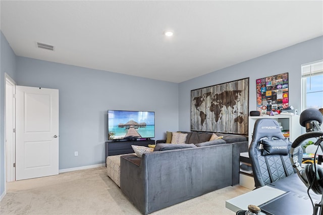 living room with visible vents, light carpet, and baseboards