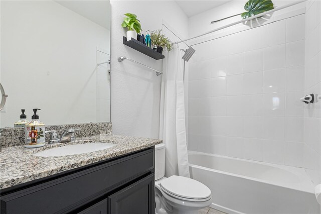 full bathroom featuring toilet, vanity, and shower / bathtub combination with curtain