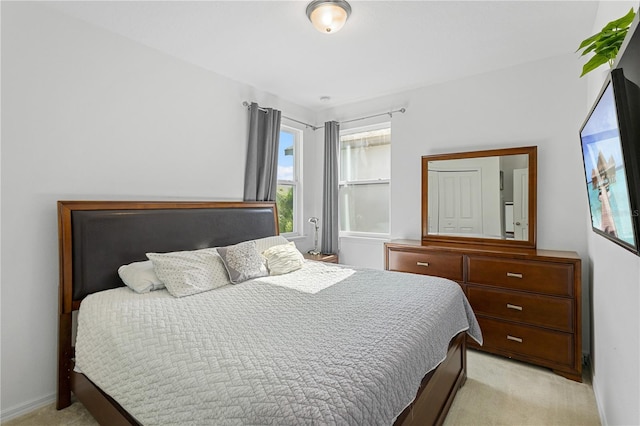 bedroom featuring light carpet