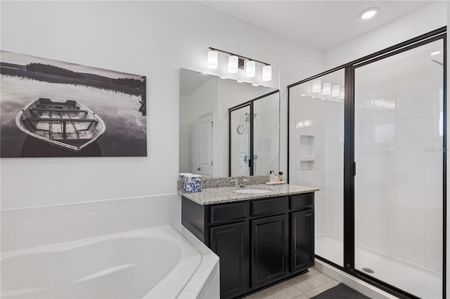 full bath with a garden tub, vanity, a stall shower, and tile patterned floors